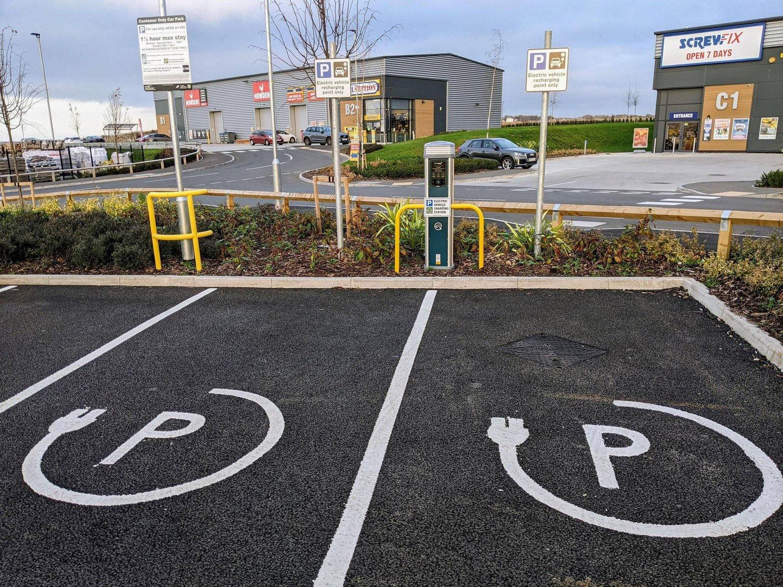 Marked EV charging bays in a workplace car park